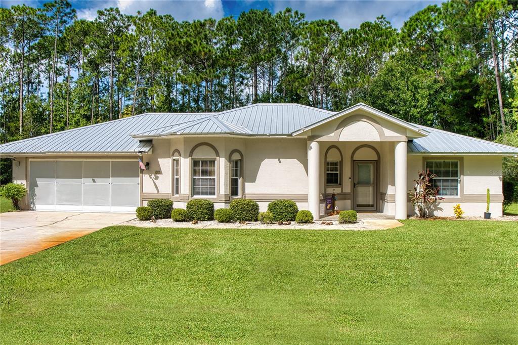 a front view of a house with a garden and porch