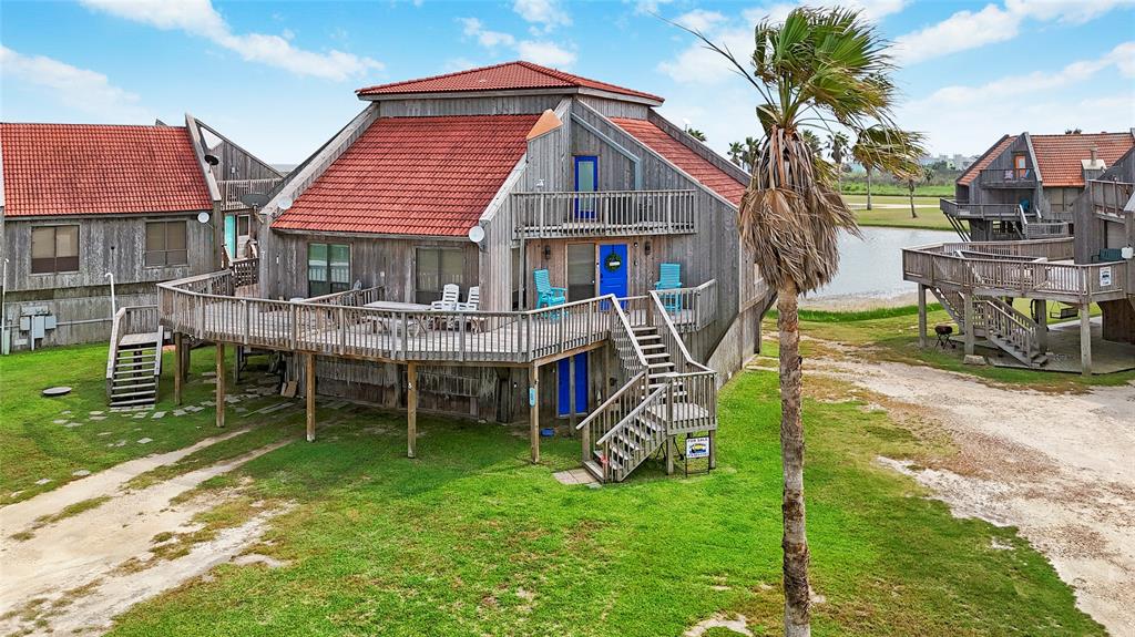 a view of a house with a yard and sitting area