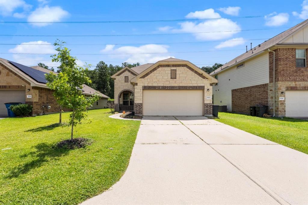 a front view of a house with a yard and garage