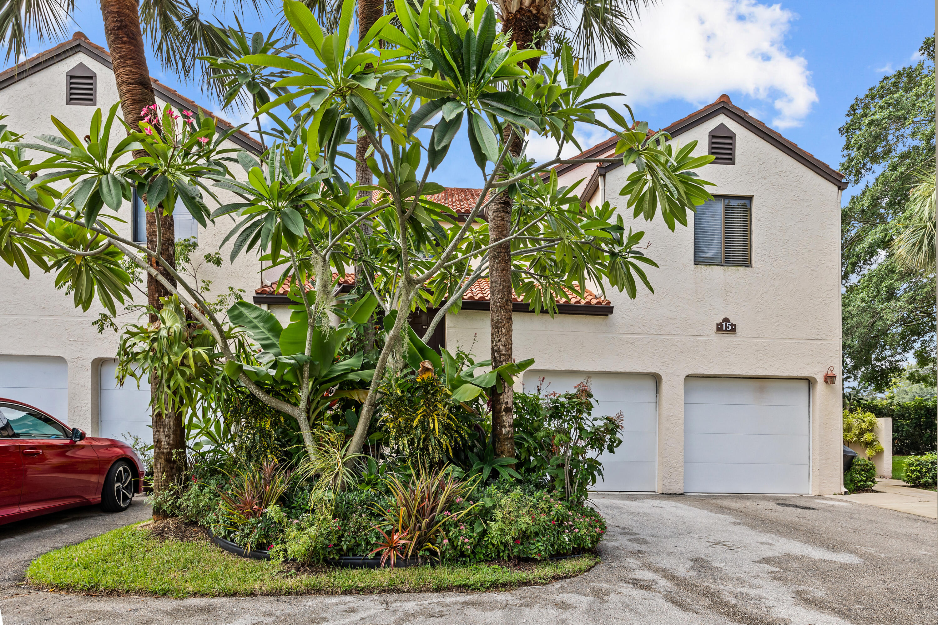 a front view of a house with a garden