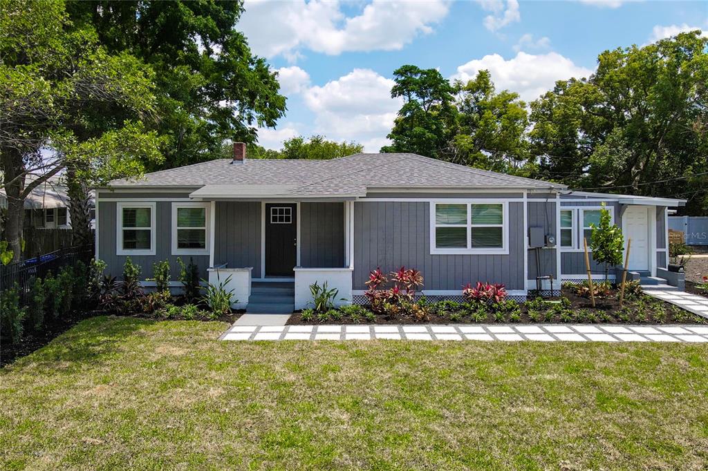 a front view of house with yard and green space