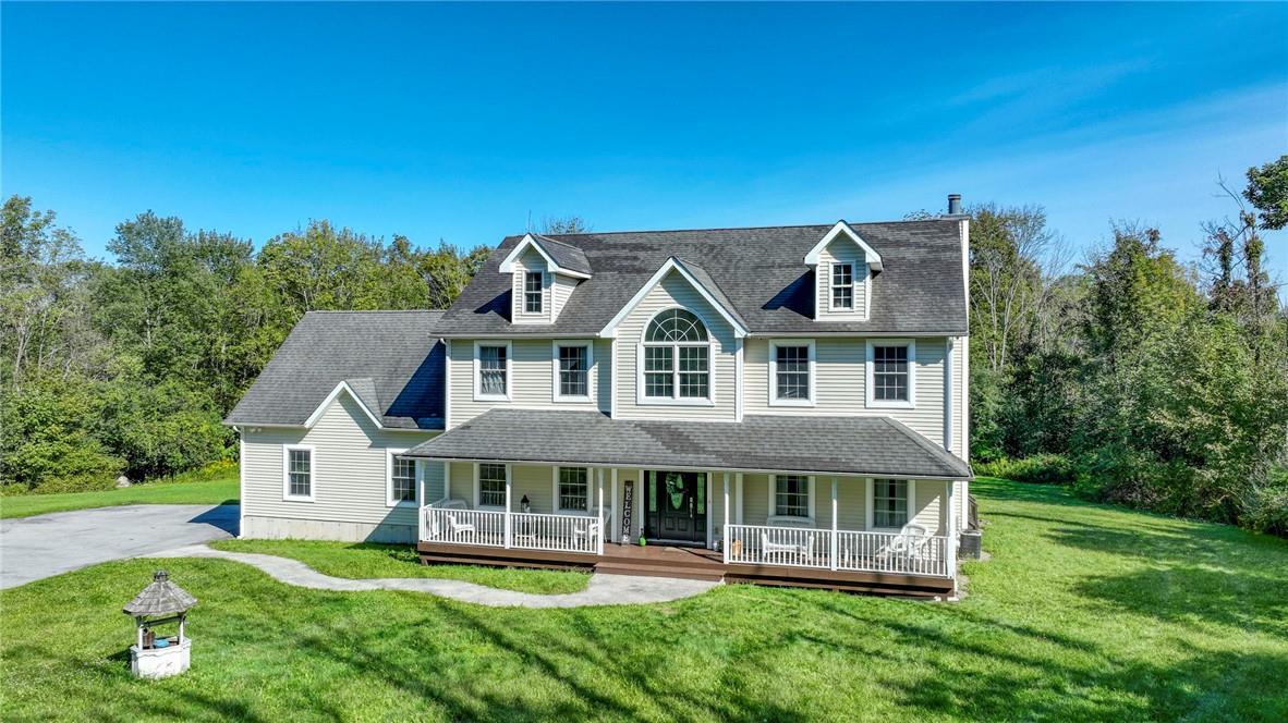 View of front of property with a porch and a front lawn