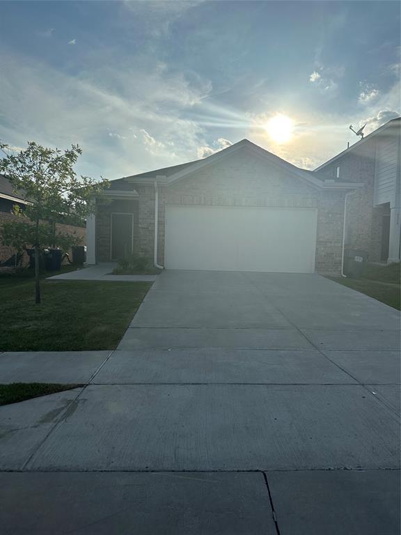 a view of a house with a yard and garage