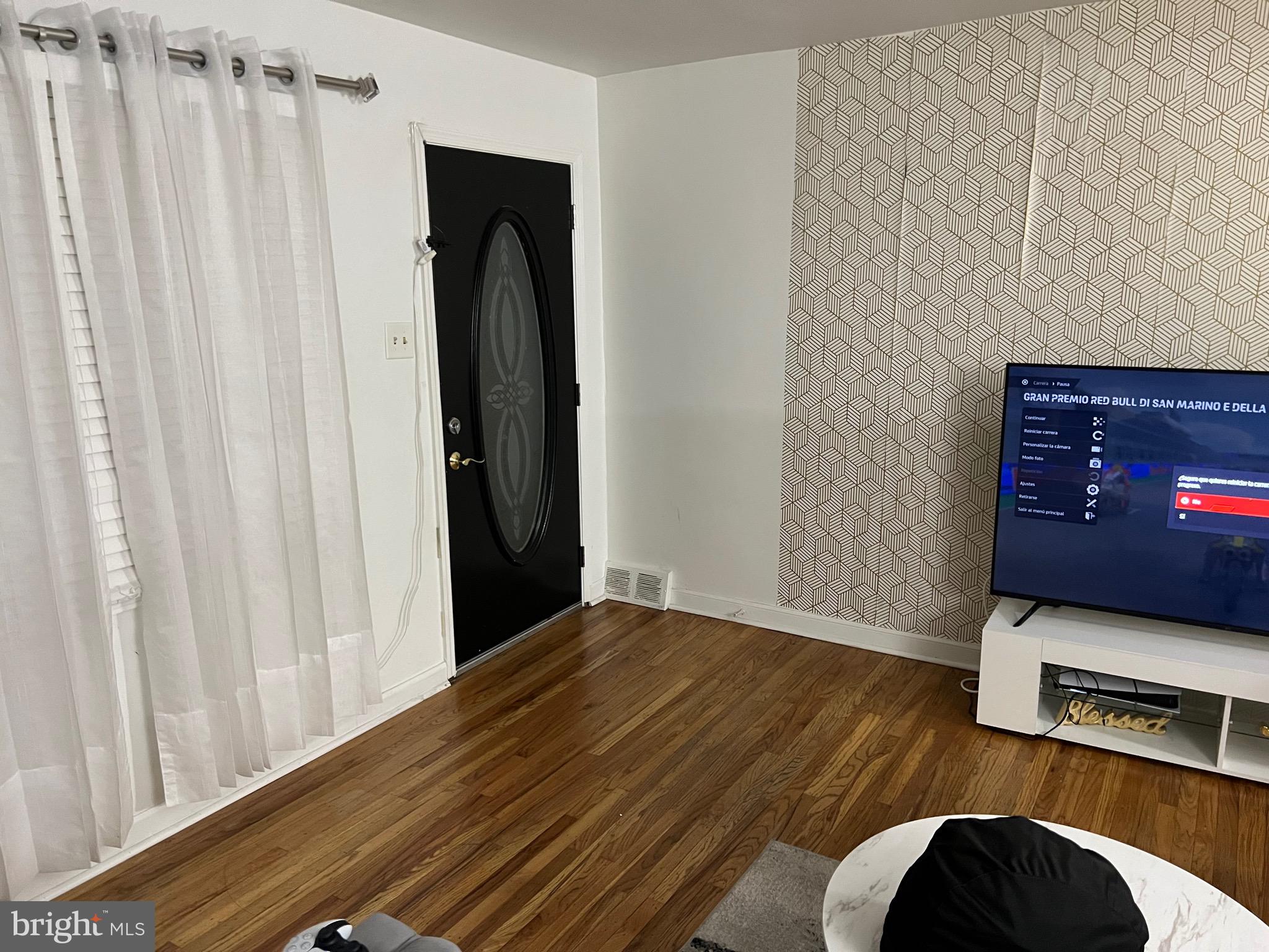 a view of a hallway with wooden floor and closet