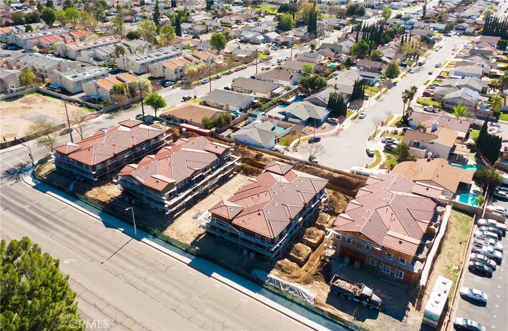 an aerial view of a residential houses with yard