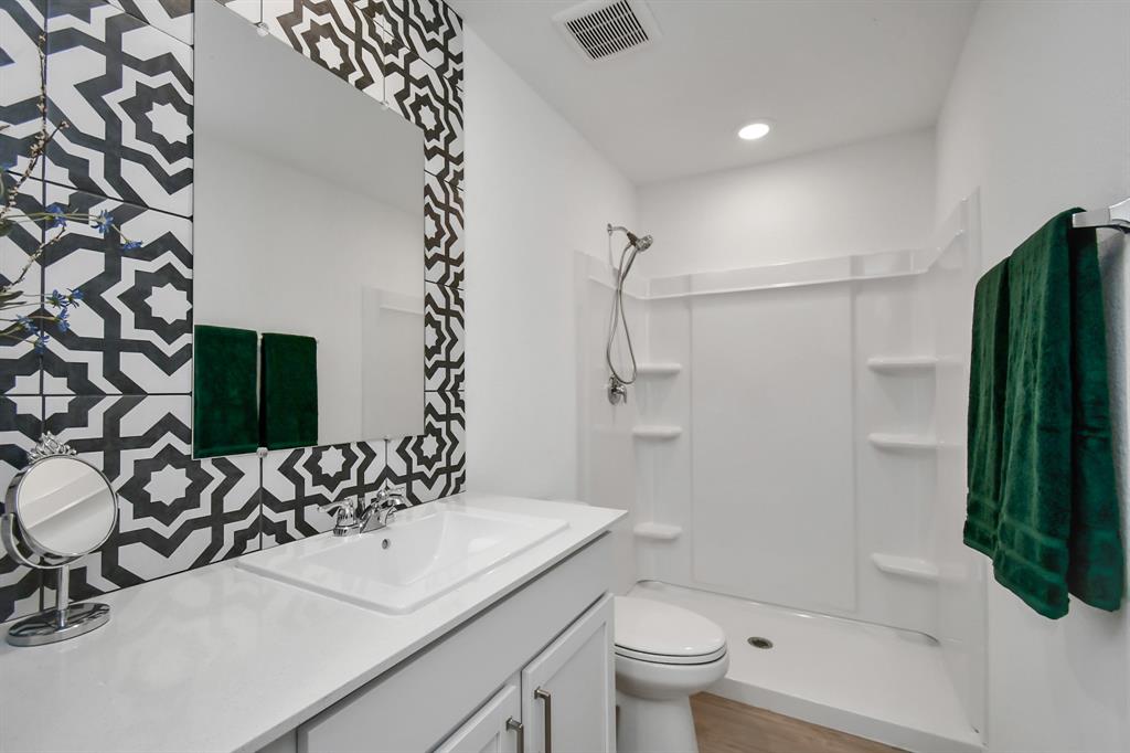 a bathroom with a sink toilet and shower