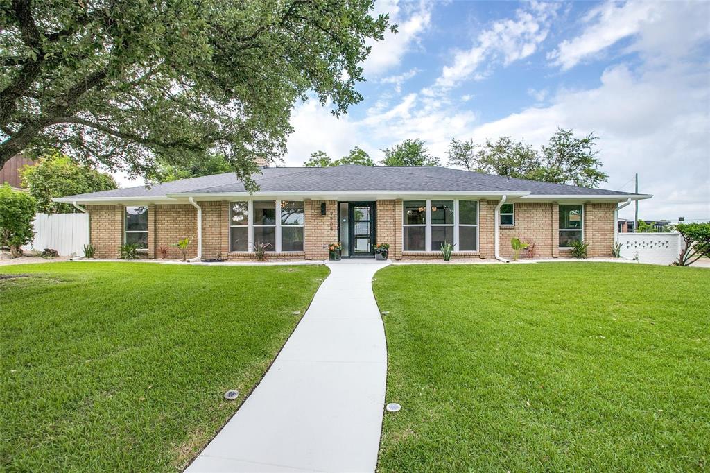 a view of house that has a yard