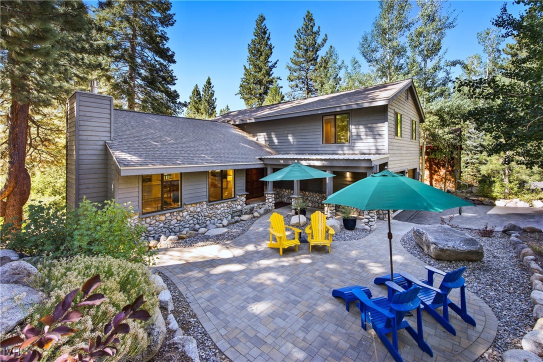 a view of a house with a yard and sitting area