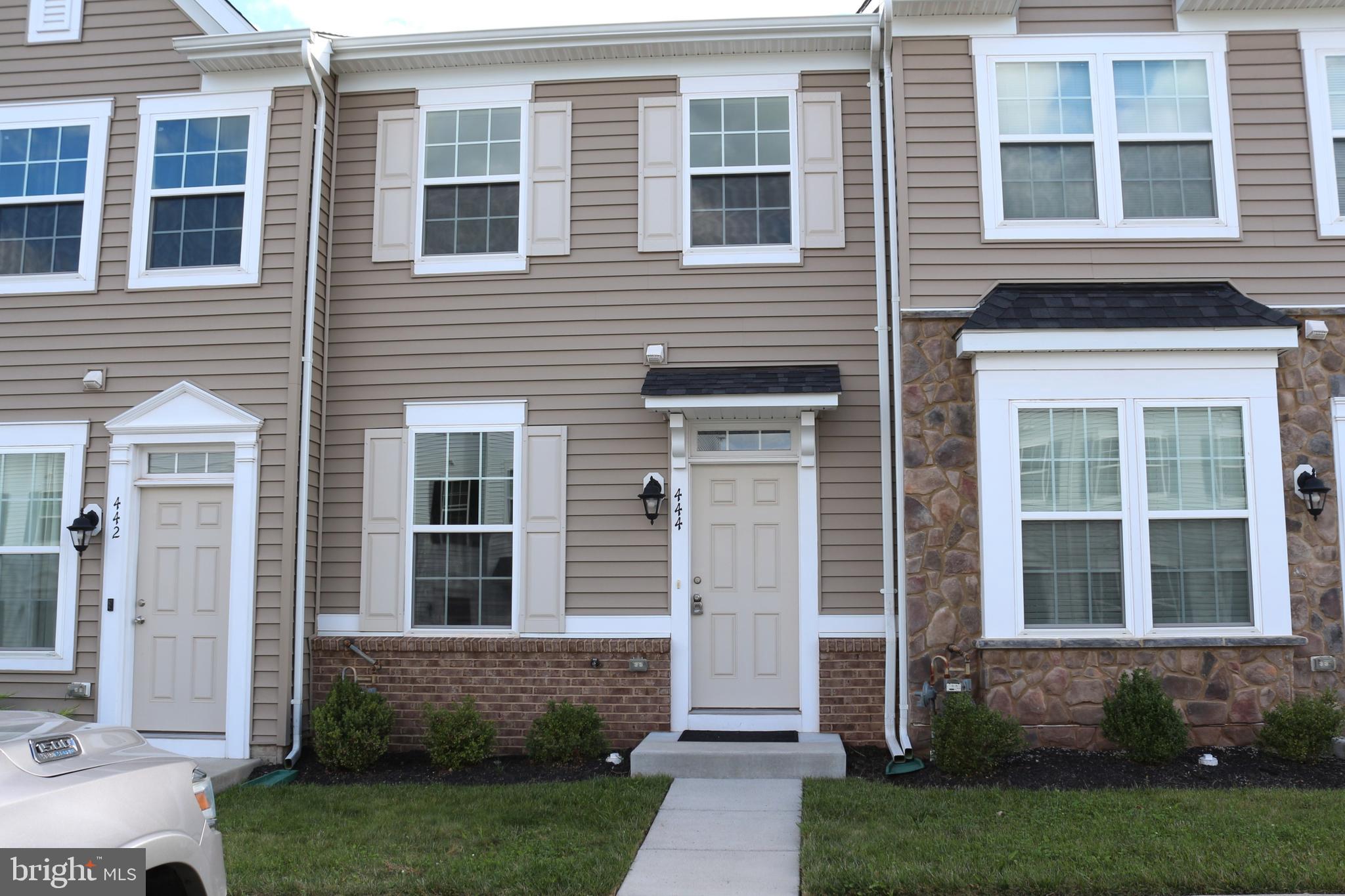 a front view of a house with a yard