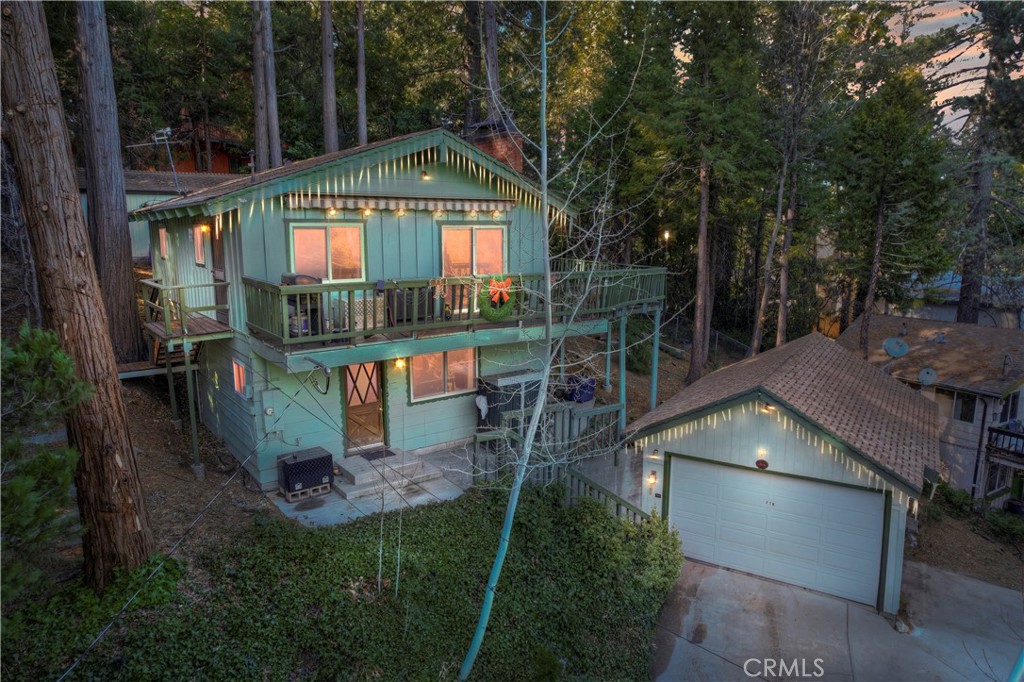 a view of a house with a yard balcony and outdoor seating