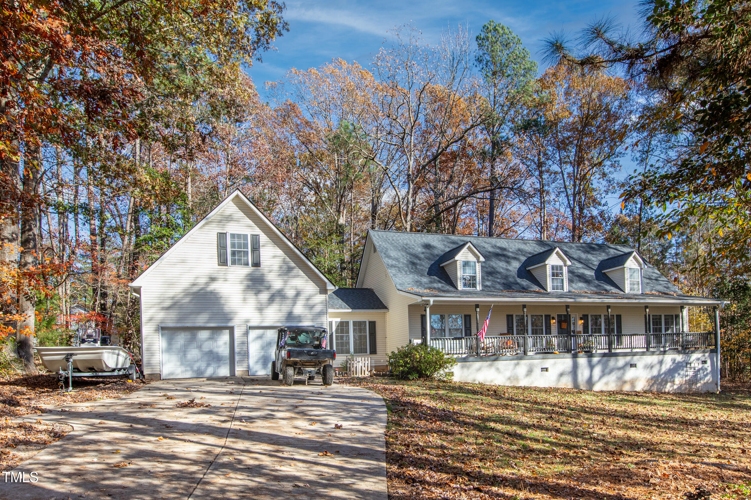 a view of a big house with a big yard and large tree