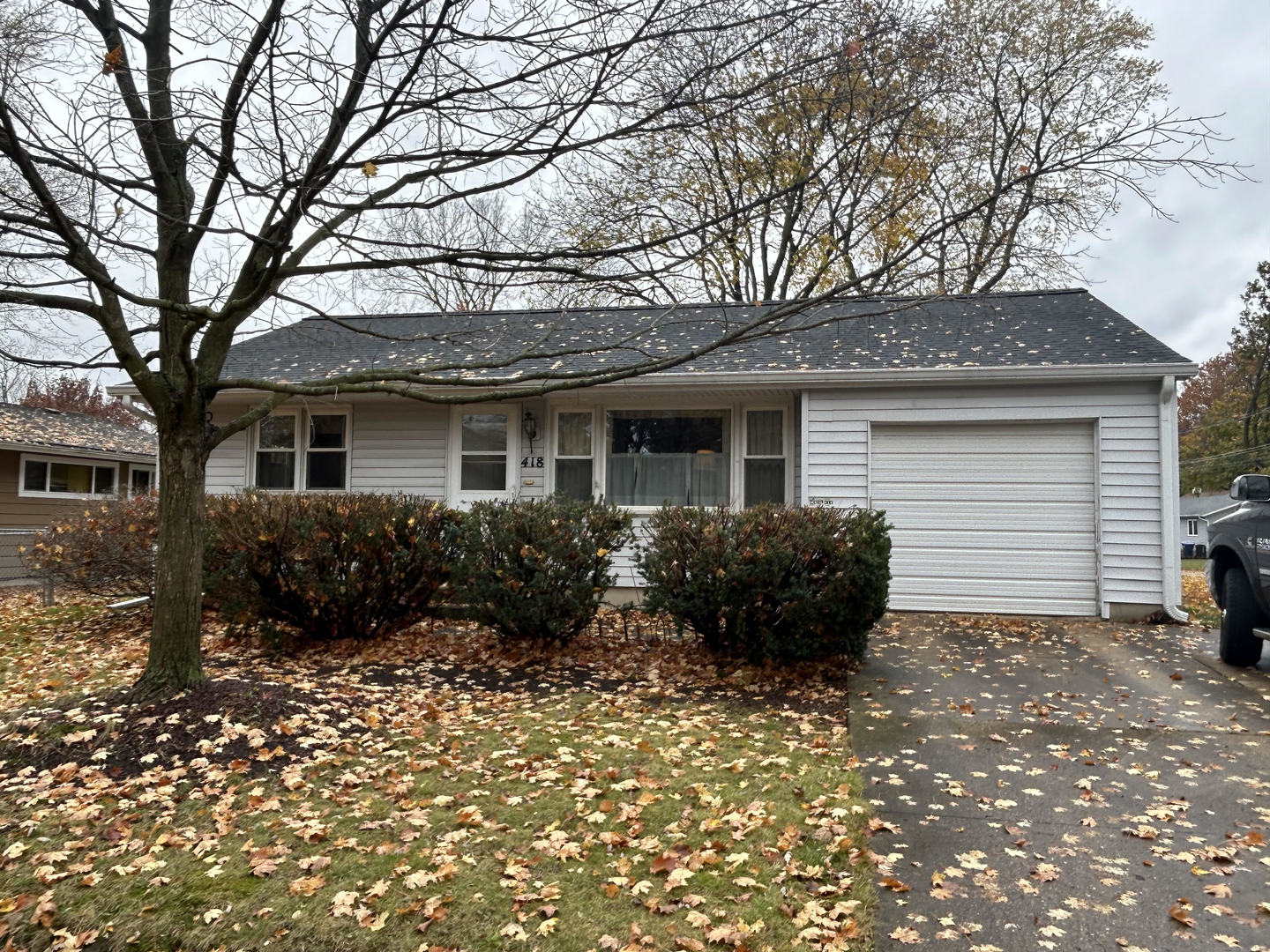 a front view of house with yard and trees