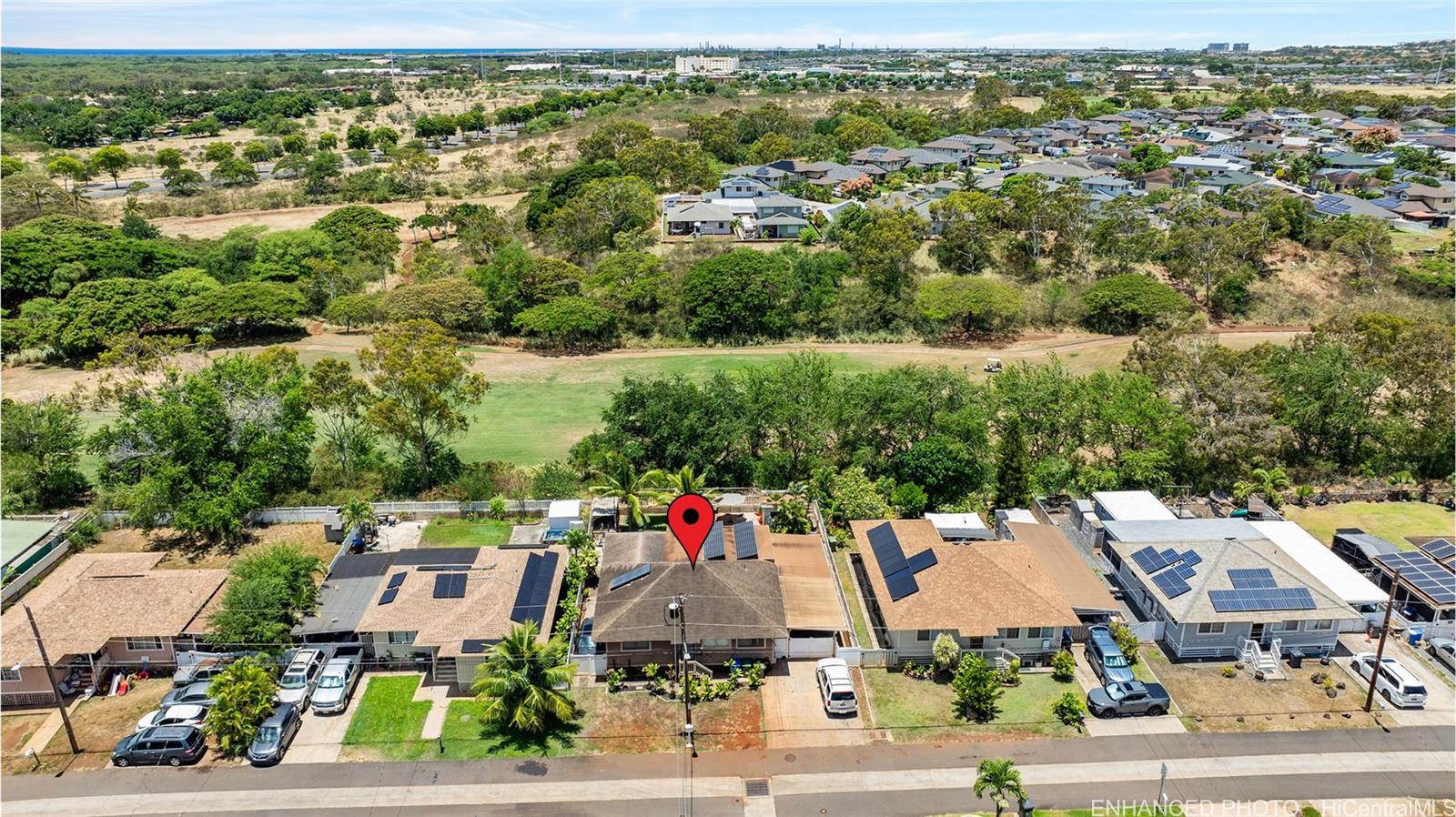 an aerial view of residential houses with outdoor space and street view