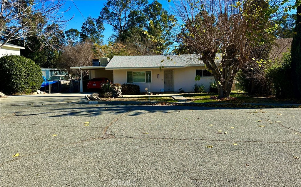 a front view of a building with trees