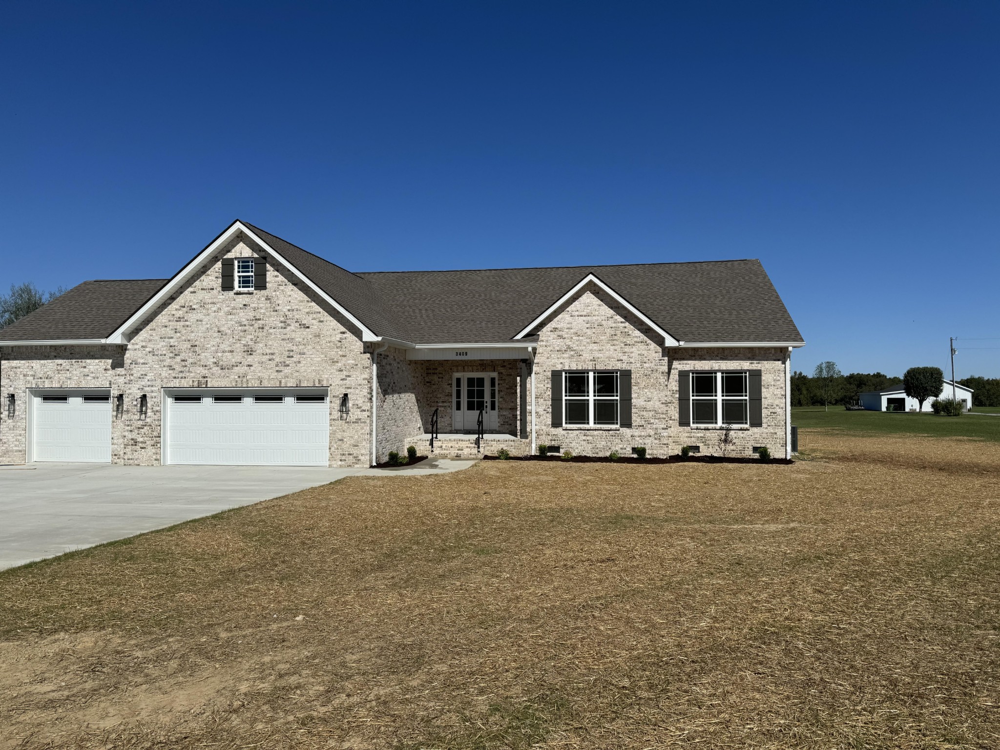 a view of house with outdoor space and parking