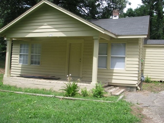 a view of house with backyard