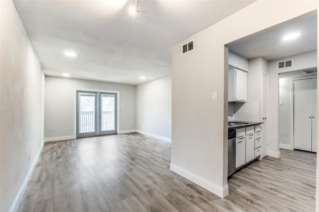 a kitchen with granite countertop a stove and a wooden floors