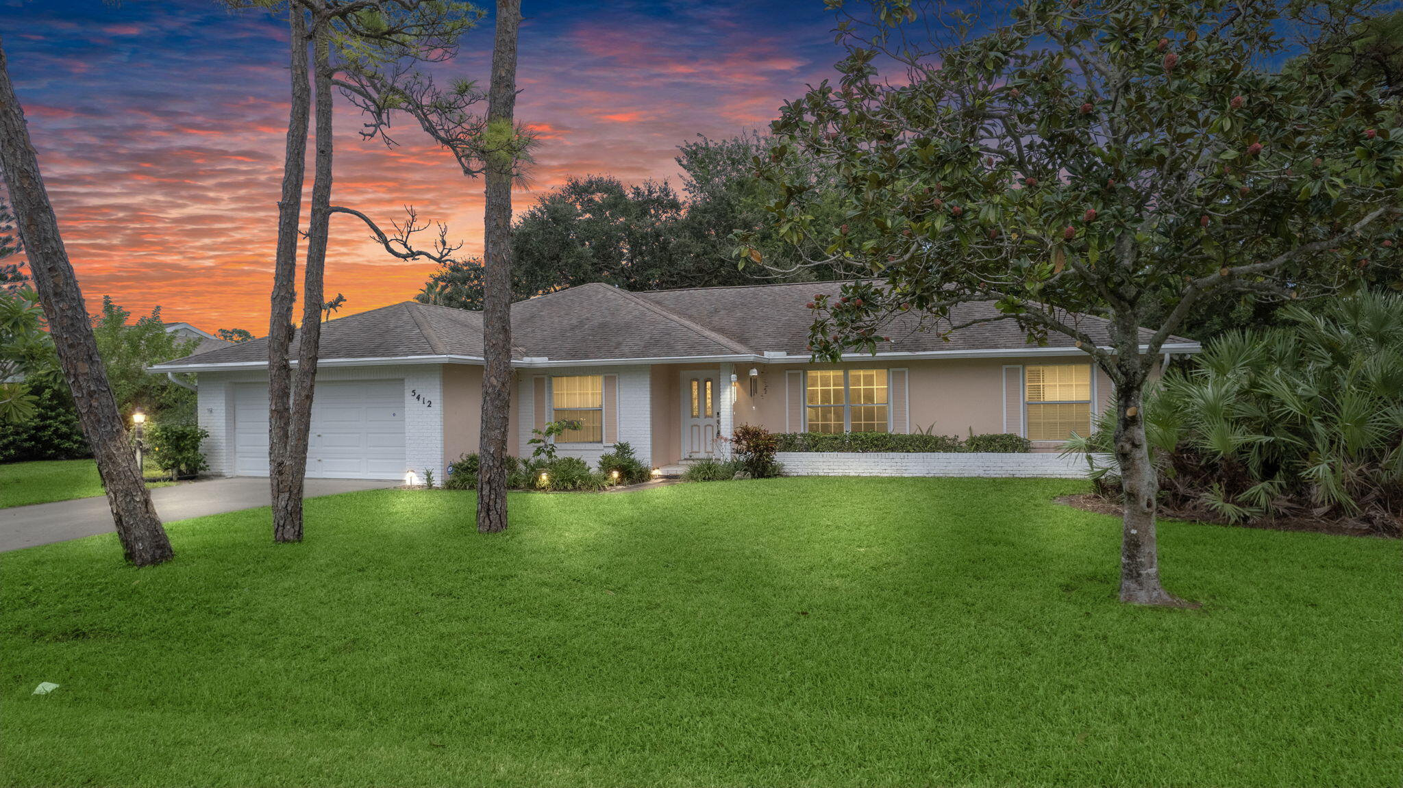 a front view of a house with a garden