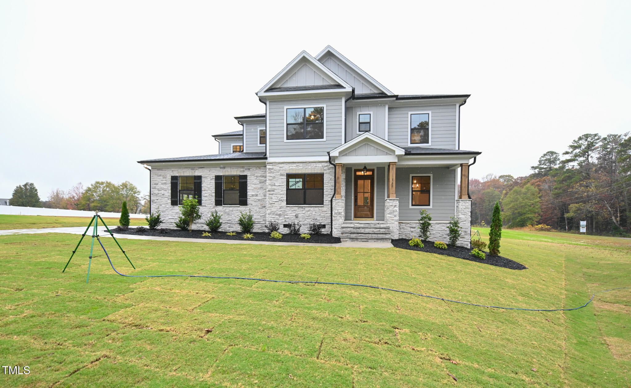 a front view of a house with swimming pool having outdoor seating