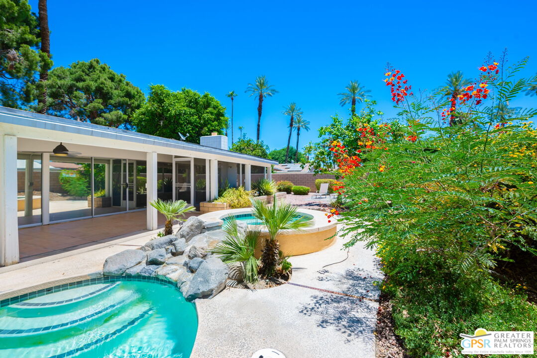 a view of a house with swimming pool and a yard