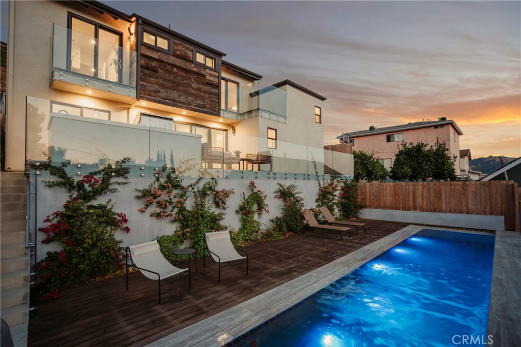 a view of a backyard with sitting area