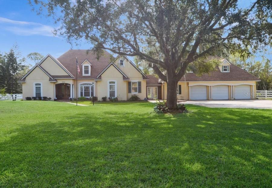 a front view of house with yard and green space