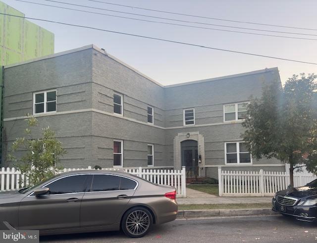 a front view of a house with a parking space