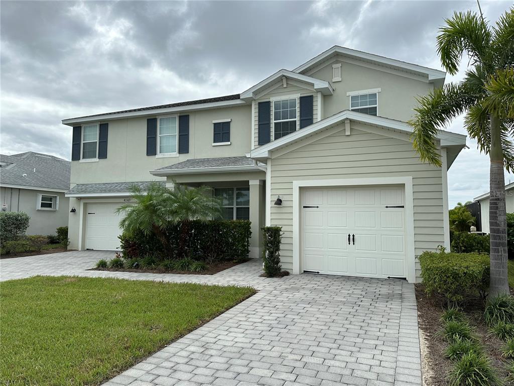 a front view of a house with a yard and garage