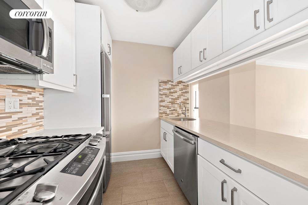 a kitchen with granite countertop a stove and a sink