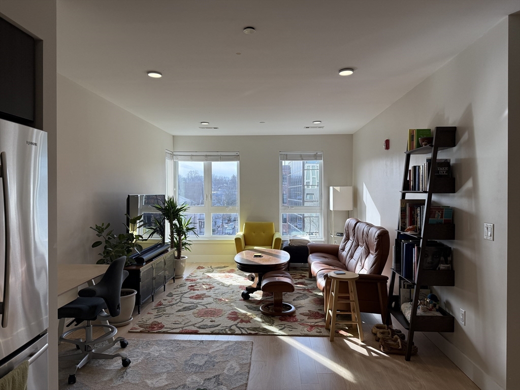 a living room with furniture a window and gym equipment