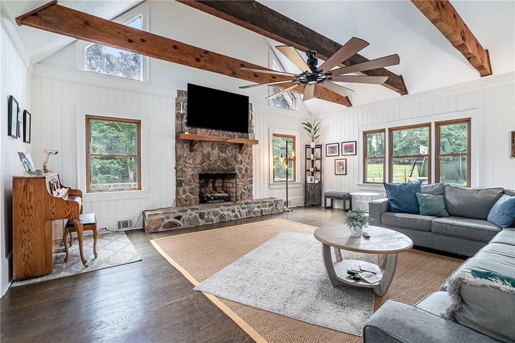 a living room with furniture a fireplace and a flat screen tv