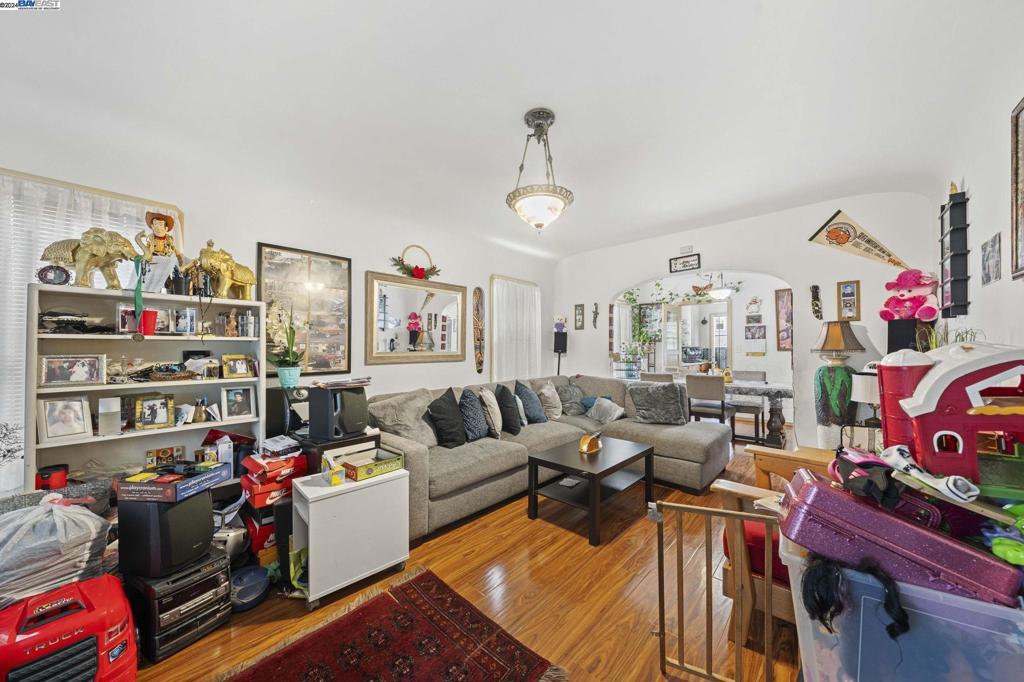 a living room with lots of furniture and a wooden floor