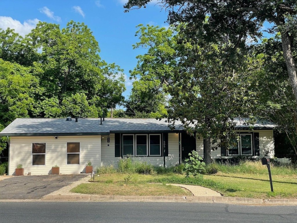 a front view of a house with a garden