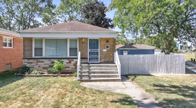 a front view of a house with a garden and plants