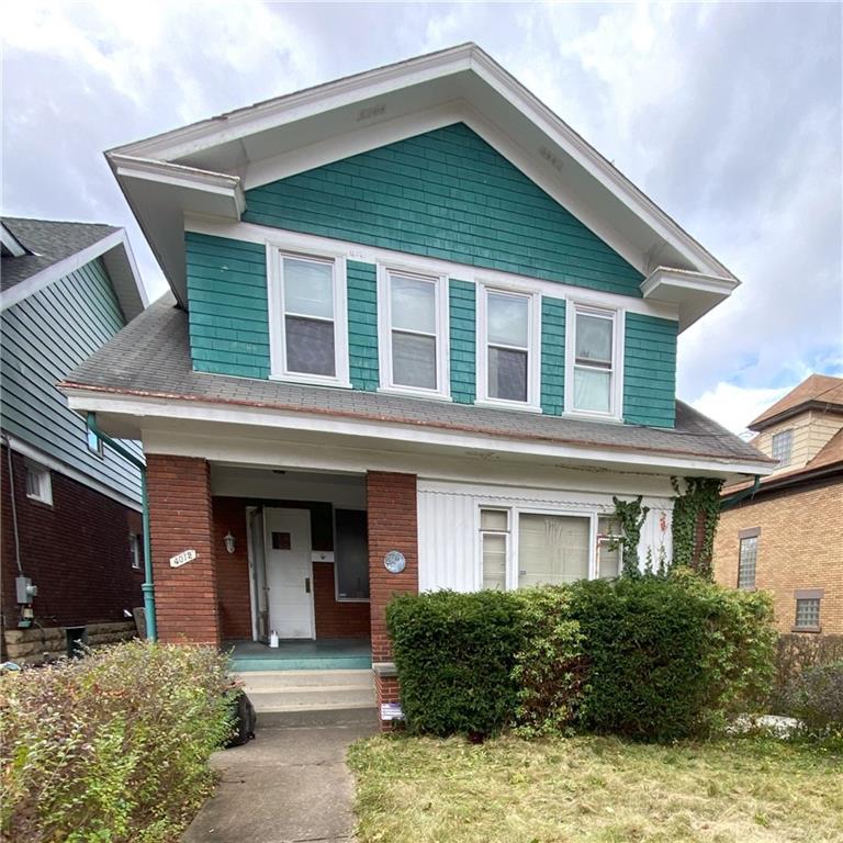 a front view of a house with yard and seating space