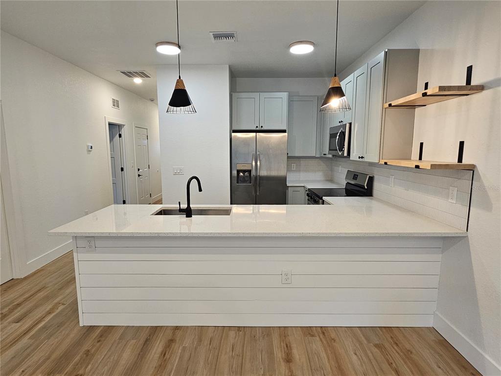 a bathroom with double vanity sink and a mirror