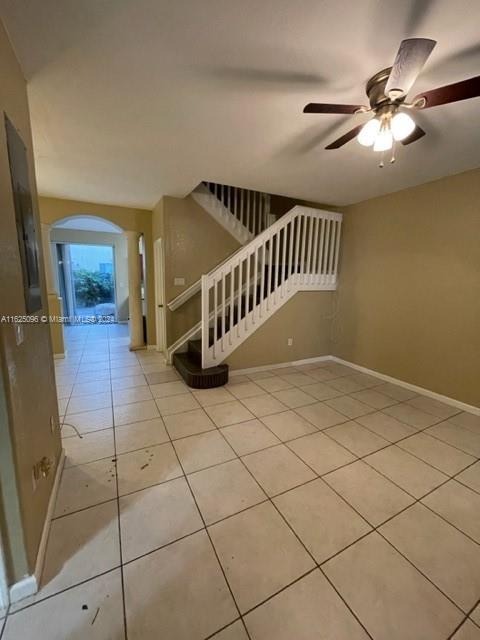 a view of staircase with white walls and chandelier