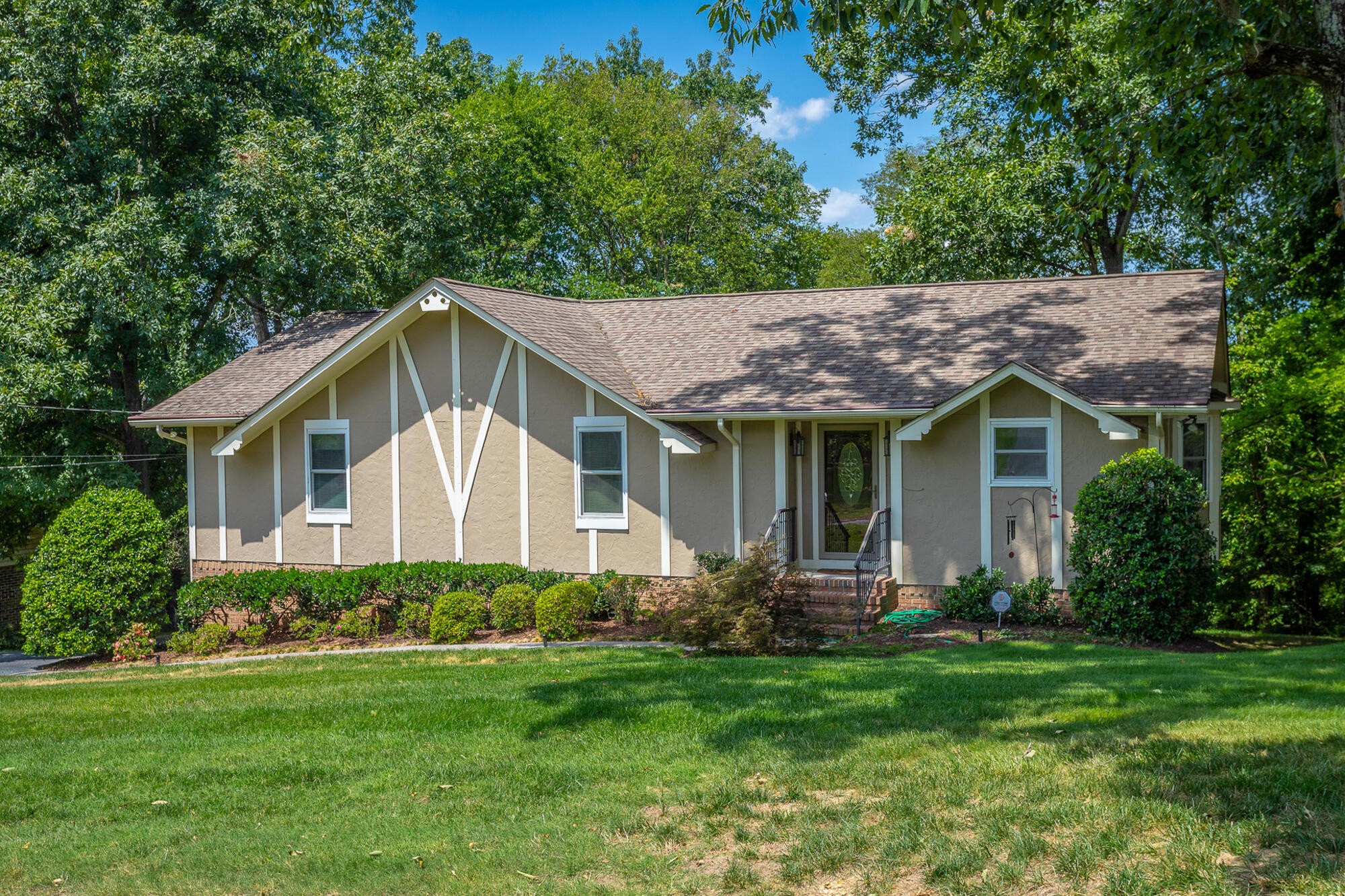 a front view of house with yard and green space