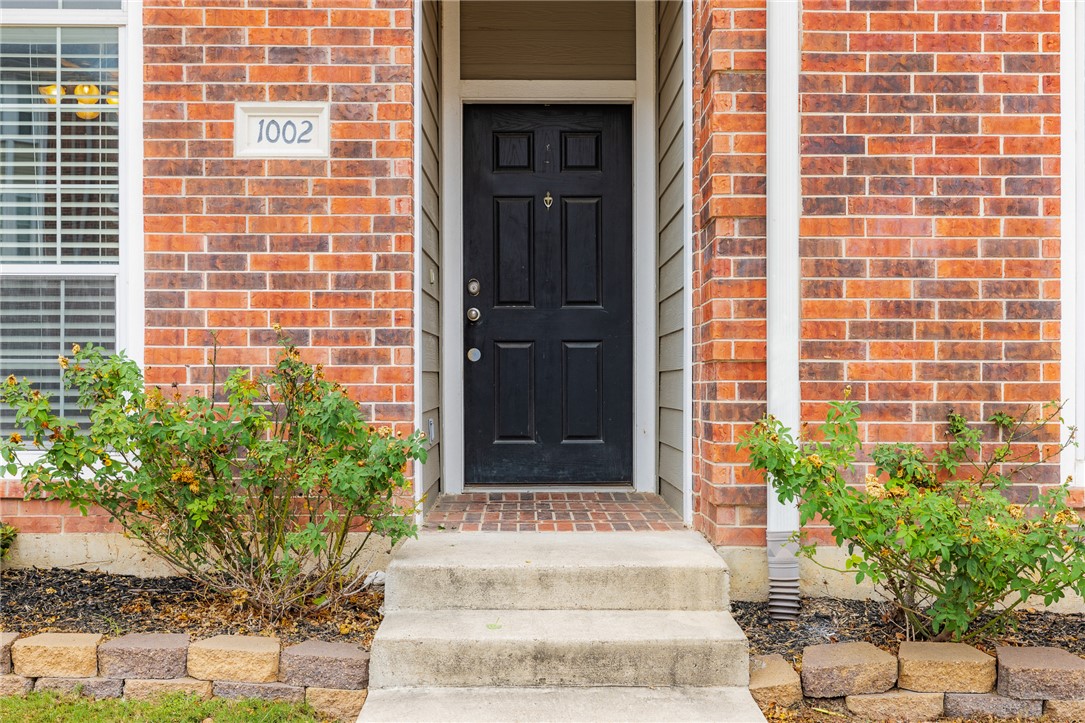 a view of front door and potted plants