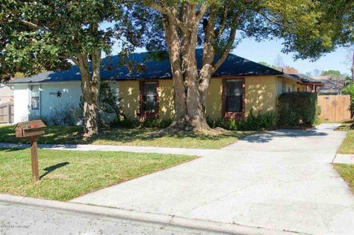 a view of a house with a yard and tree s