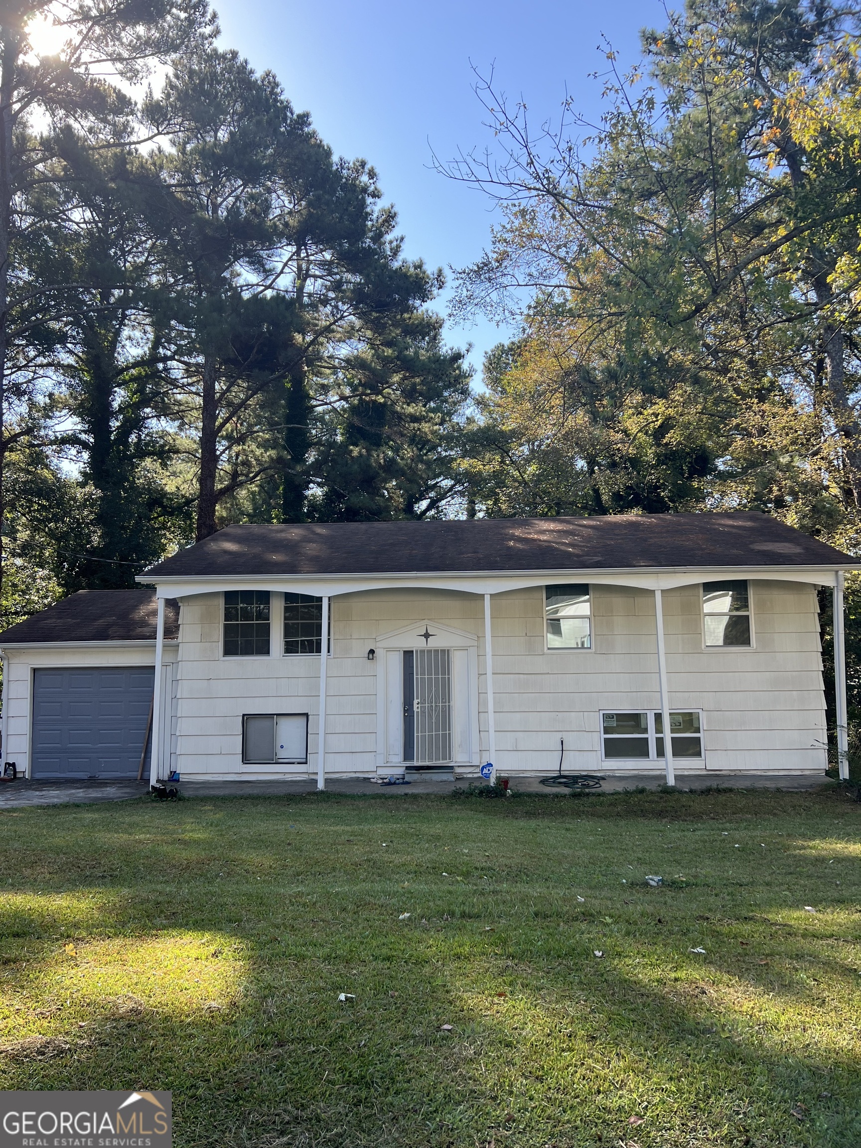 a front view of house with yard and green space