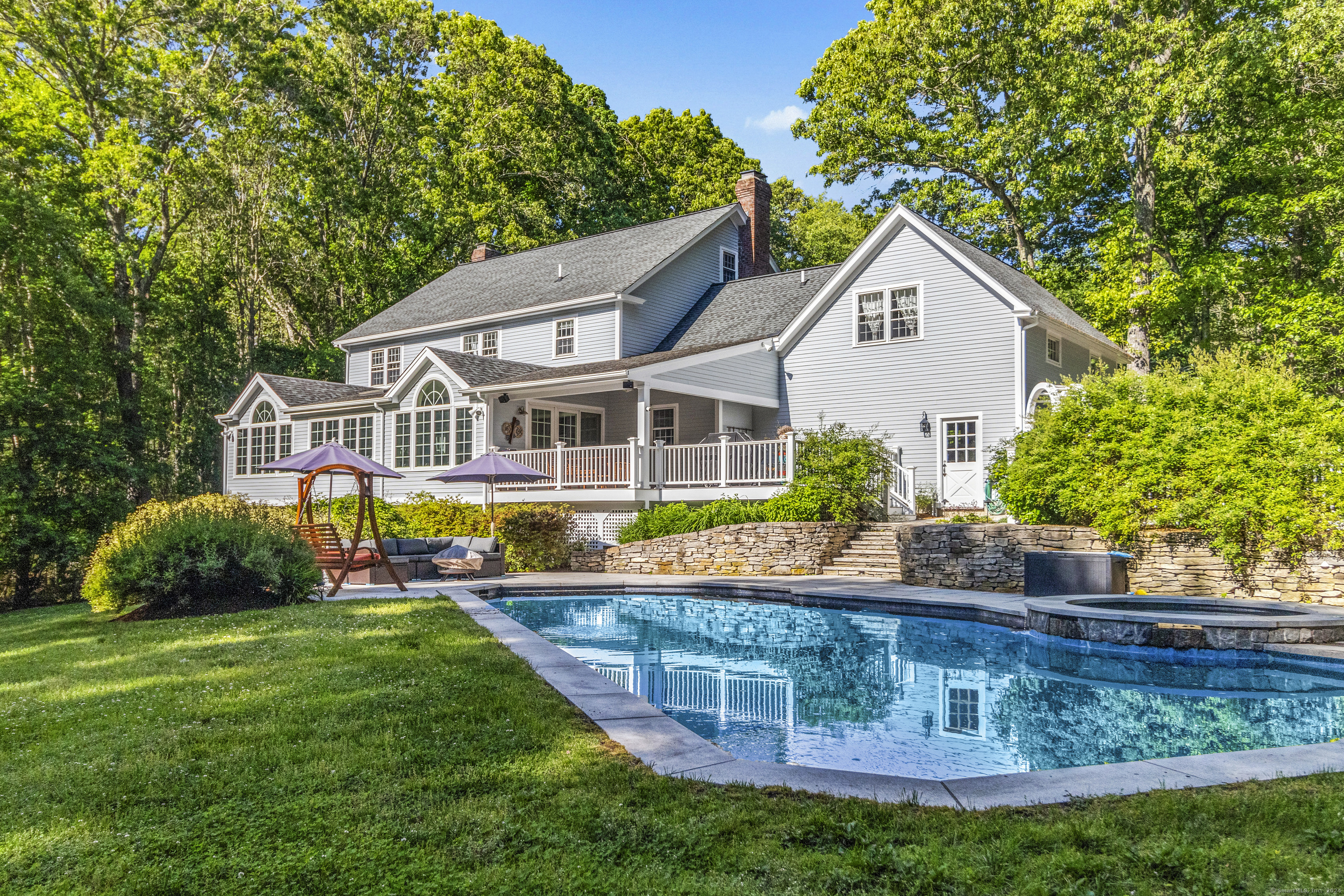 a view of house with garden and tall trees