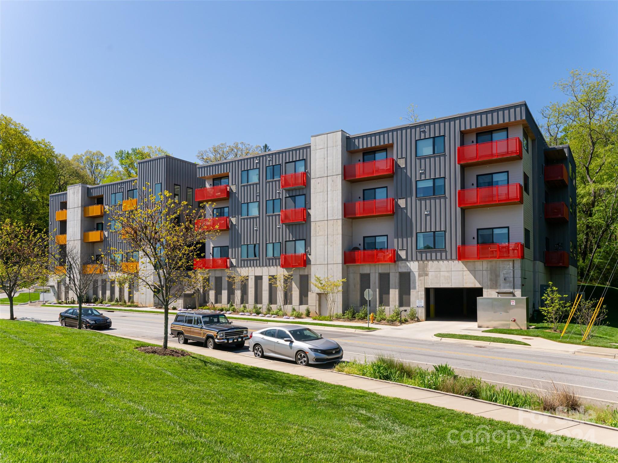 a front view of building with outdoor seating and yard