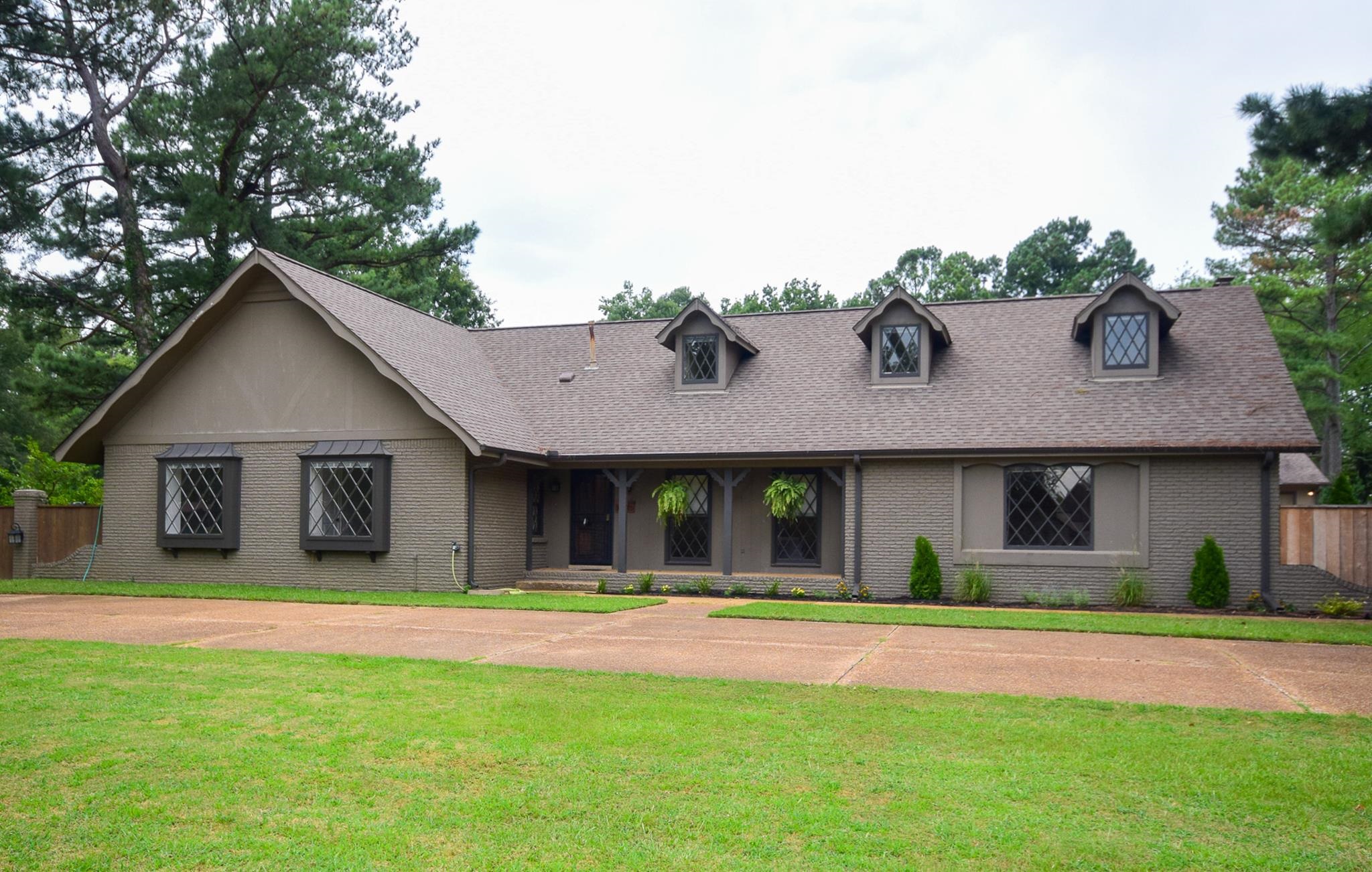 a front view of a house with a garden