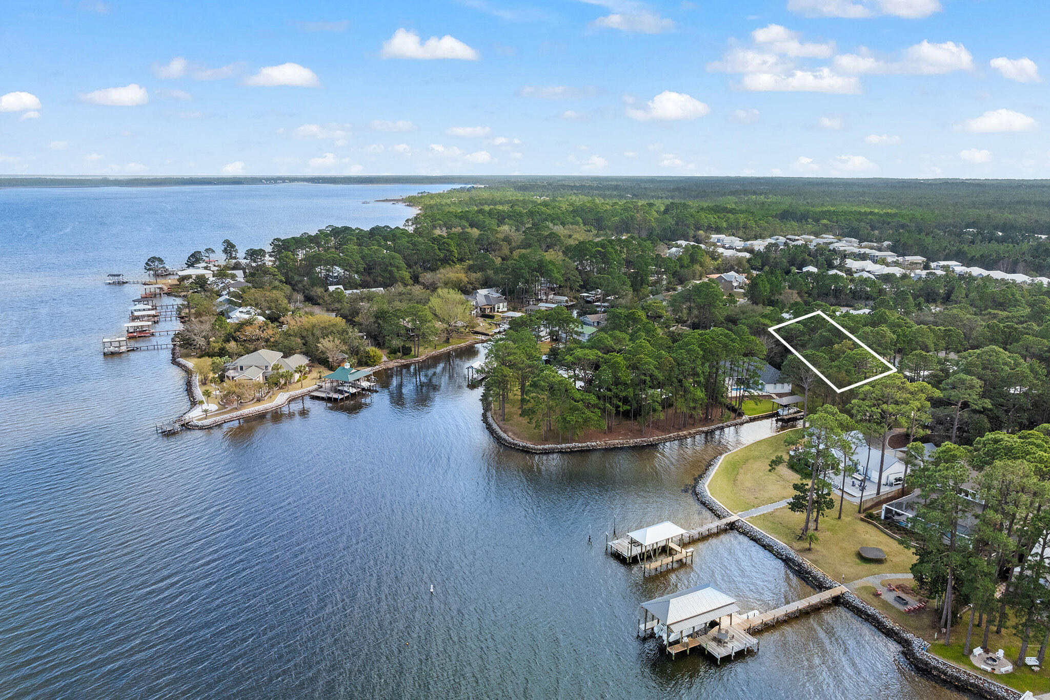 an aerial view of a house with swimming pool and lake view