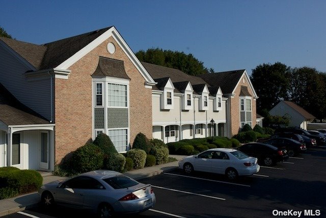 a view of a white house with a yard