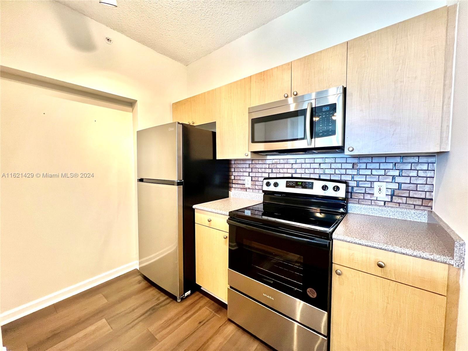 a kitchen with a stove microwave and refrigerator