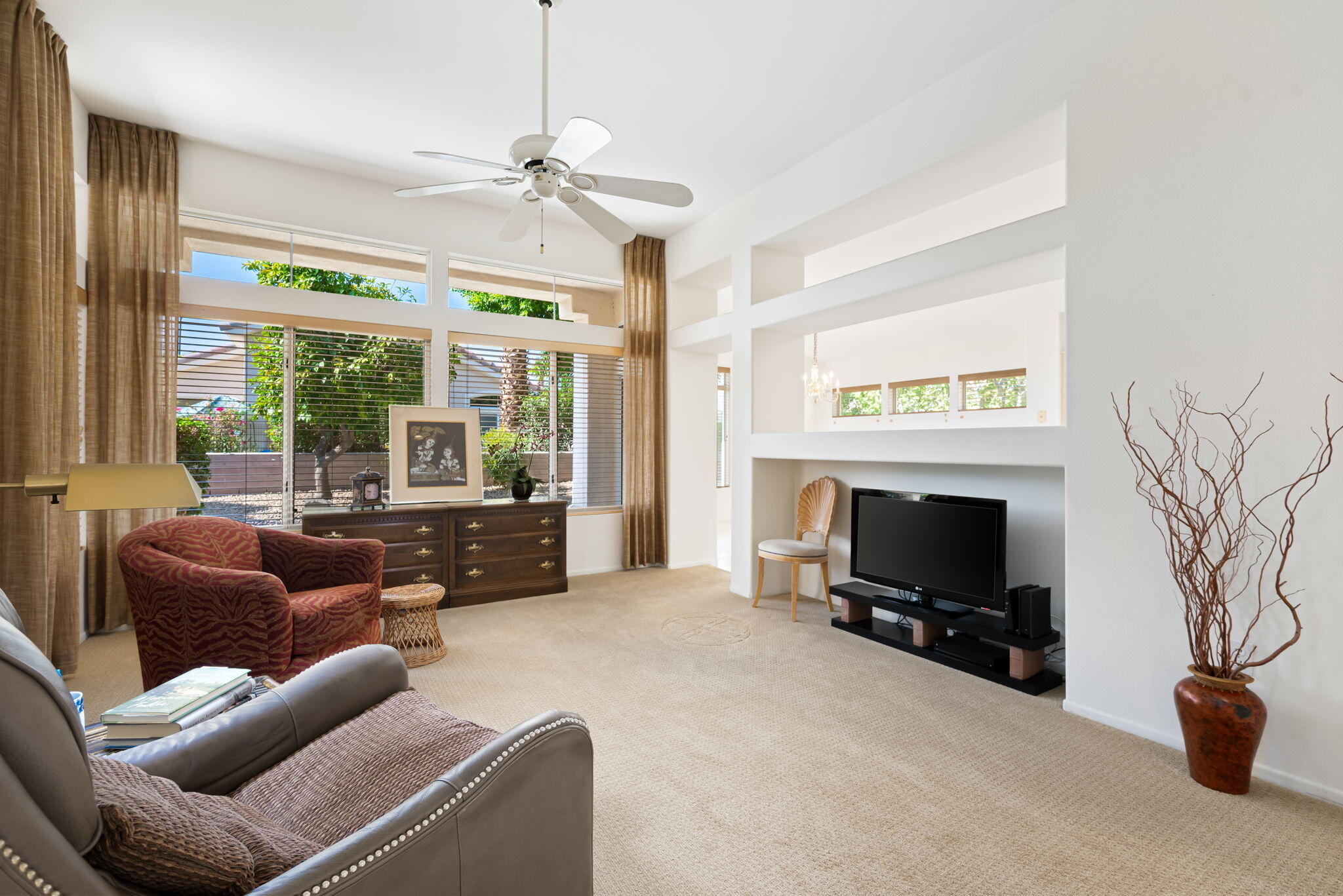 a living room with furniture a flat screen tv and a fireplace