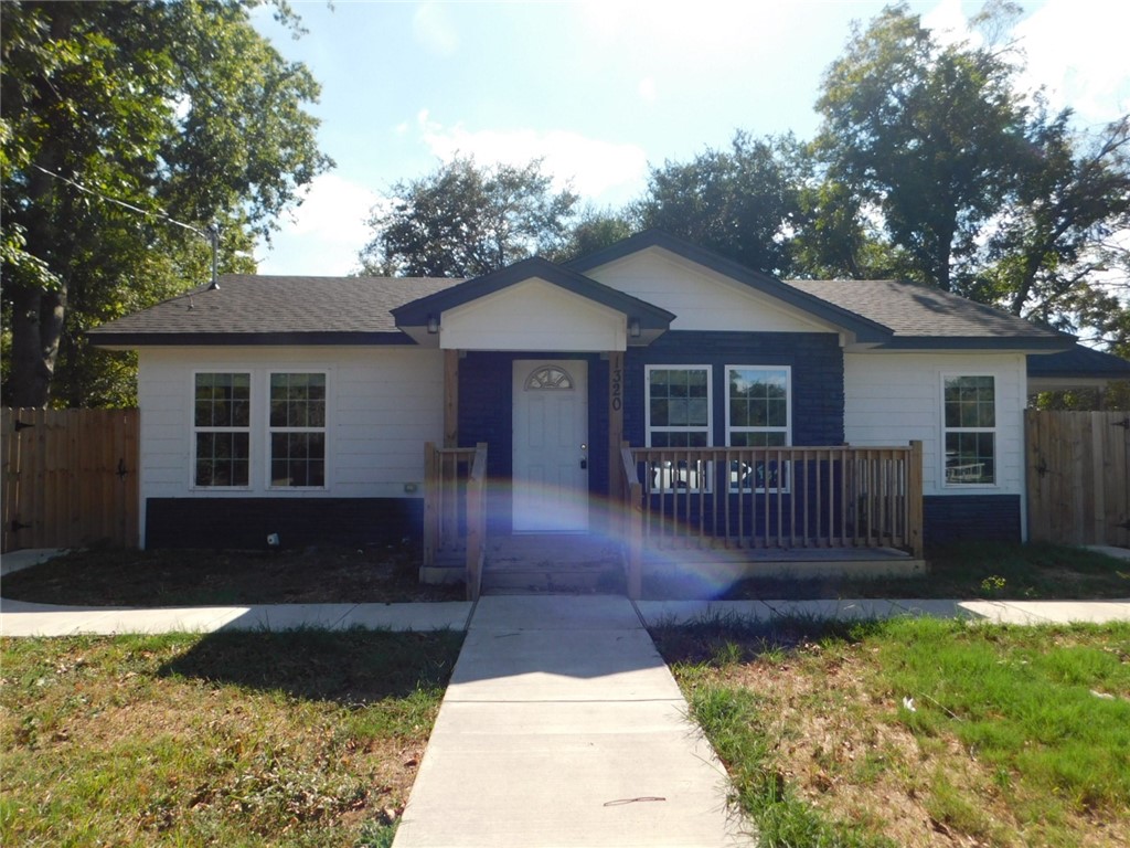 a view of house with a yard in front of it