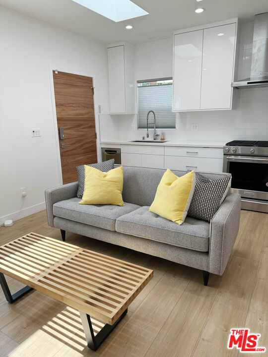 a living room with furniture and kitchen view